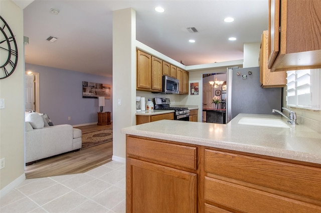 1768 SW 156th Ln, Ocala, FL 34473 - kitchen featuring stainless steel appliances, light tile patterned floors, a peninsula, light countertops, and recessed lighting
