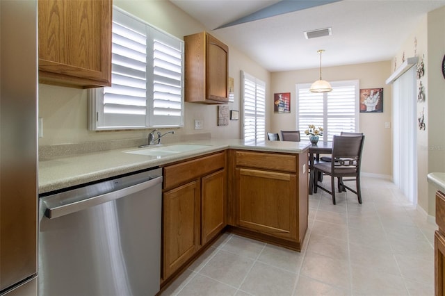 1768 SW 156th Ln, Ocala, FL 34473 - kitchen with stainless steel dishwasher, brown cabinets, and light countertops