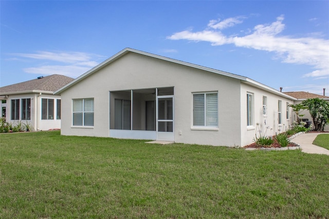 1768 SW 156th Ln, Ocala, FL 34473 - back of property featuring stucco siding, a sunroom, and a lawn