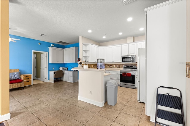 6551 SE 11th Loop, Ocala, FL 34472 - kitchen featuring appliances with stainless steel finishes, open shelves, light tile patterned floors, heating unit, and white cabinets
