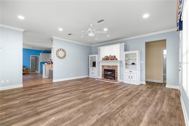 6551 SE 11th Loop, Ocala, FL 34472 - unfurnished living room with a ceiling fan, wood finished floors, crown molding, recessed lighting, and a fireplace