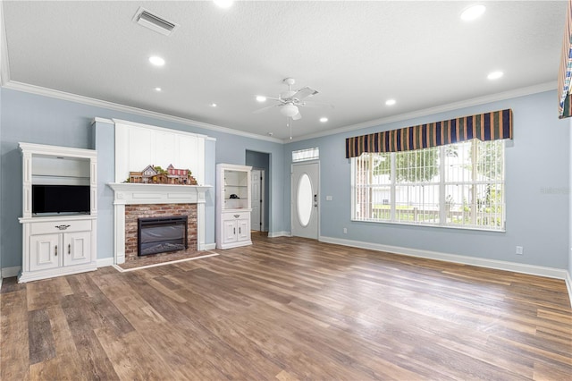 6551 SE 11th Loop, Ocala, FL 34472 - unfurnished living room with a ceiling fan, crown molding, wood finished floors, a brick fireplace, and recessed lighting