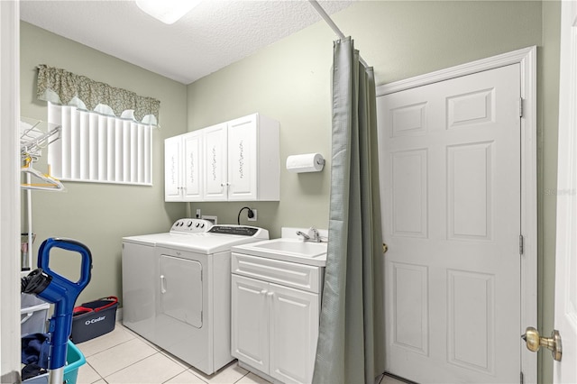6551 SE 11th Loop, Ocala, FL 34472 - laundry room with cabinet space, independent washer and dryer, light tile patterned floors, and a textured ceiling