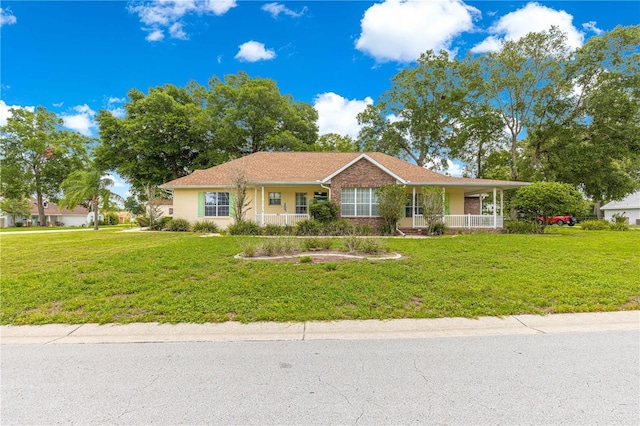 6551 SE 11th Loop, Ocala, FL 34472 - view of front of house with a front lawn and covered porch