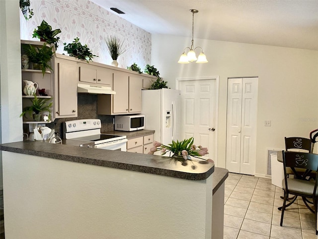 2305 NE 40th Ave, Ocala, FL 34470 - kitchen with white appliances, under cabinet range hood, a peninsula, and dark countertops