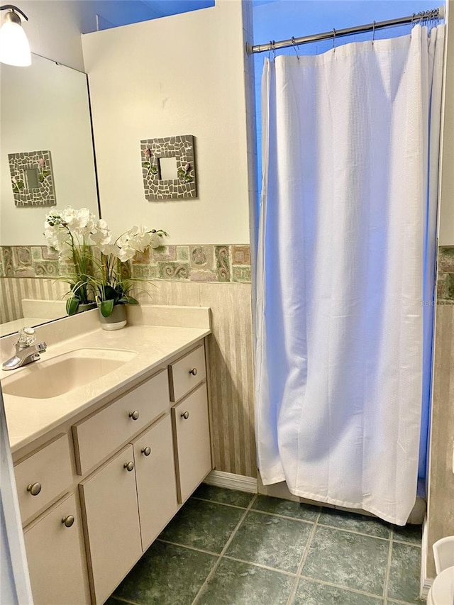 2305 NE 40th Ave, Ocala, FL 34470 - bathroom with vanity, a wainscoted wall, and a shower with curtain