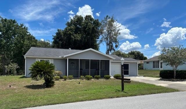 8650 SW 108th Pl, Ocala, FL 34481 - ranch-style home with a garage, concrete driveway, a front lawn, and a sunroom