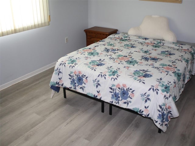 8650 SW 108th Pl, Ocala, FL 34481 - bedroom with light wood finished floors and baseboards