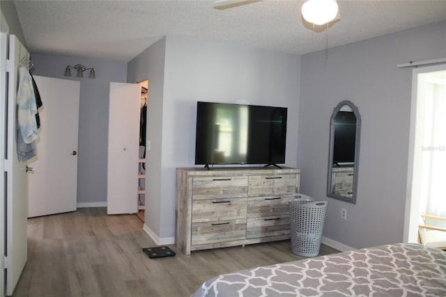 8650 SW 108th Pl, Ocala, FL 34481 - bedroom with wood finished floors, arched walkways, and a ceiling fan