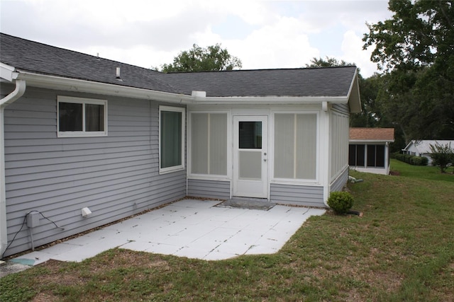 8650 SW 108th Pl, Ocala, FL 34481 - back of house with a patio, a lawn, roof with shingles, and a sunroom