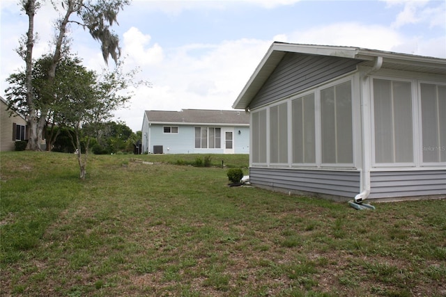 8650 SW 108th Pl, Ocala, FL 34481 - view of property exterior featuring a sunroom and a lawn