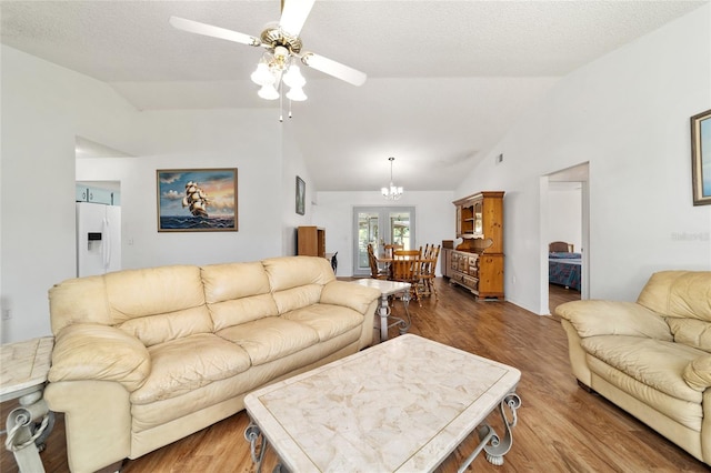 475 NE 155th Pl, Citra, FL 32113 - living room featuring vaulted ceiling, ceiling fan, wood finished floors, and a chandelier
