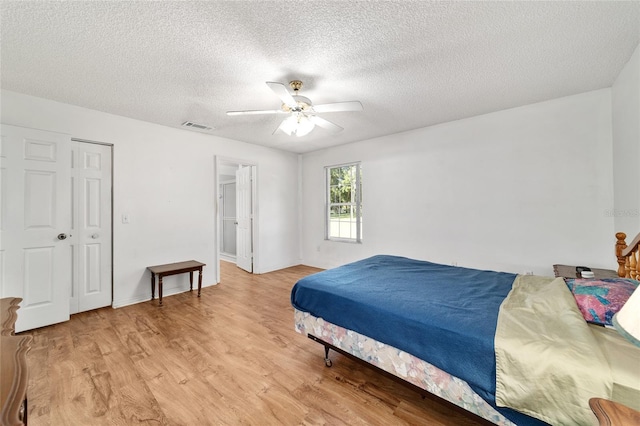 475 NE 155th Pl, Citra, FL 32113 - bedroom with light wood-style floors, a textured ceiling, and ceiling fan