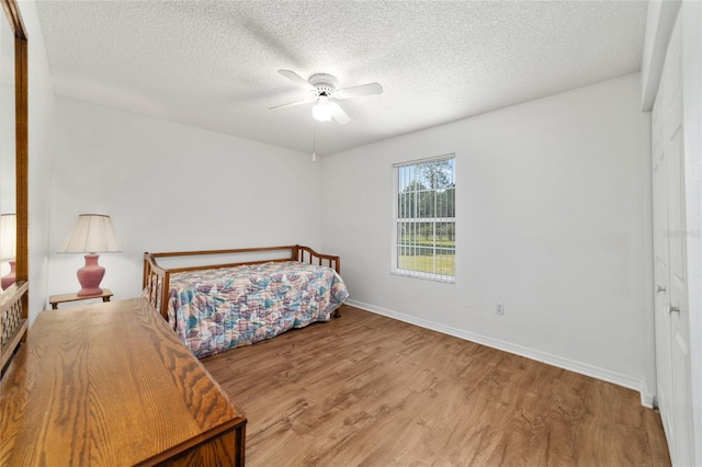 475 NE 155th Pl, Citra, FL 32113 - bedroom featuring wood finished floors, a textured ceiling, and ceiling fan