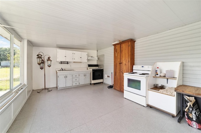 475 NE 155th Pl, Citra, FL 32113 - kitchen featuring white electric range, white range, white cabinets, light countertops, and light flooring