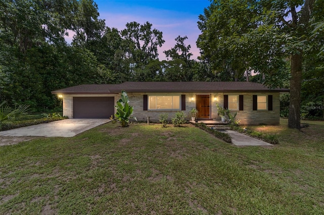 19130 NW 60th Ave, Reddick, FL 32686 - ranch-style house with concrete driveway, an attached garage, and a lawn