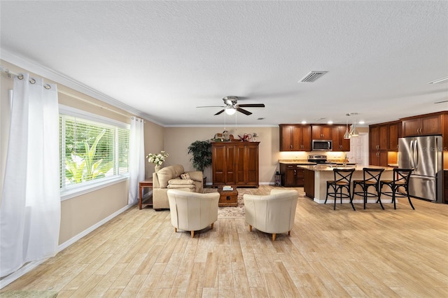 19130 NW 60th Ave, Reddick, FL 32686 - living area with light wood-style floors, crown molding, a ceiling fan, a textured ceiling, and recessed lighting
