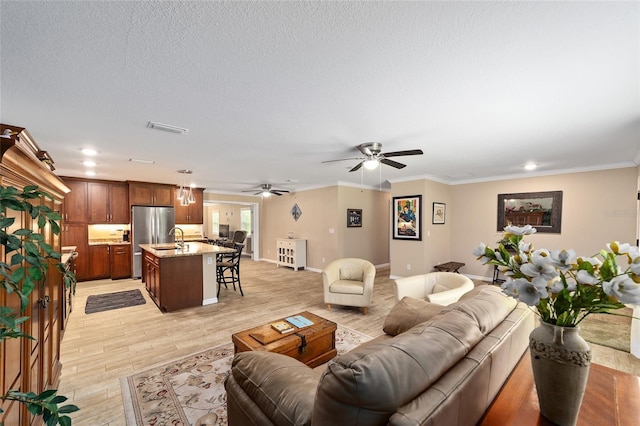 19130 NW 60th Ave, Reddick, FL 32686 - living area featuring a ceiling fan, light wood-style flooring, crown molding, recessed lighting, and a textured ceiling
