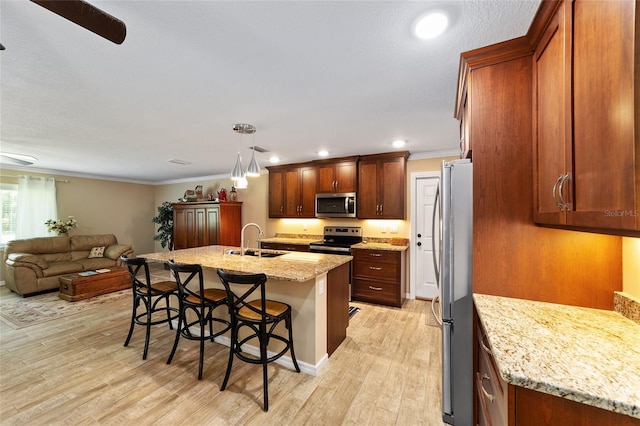19130 NW 60th Ave, Reddick, FL 32686 - kitchen featuring appliances with stainless steel finishes, a kitchen bar, light wood-style floors, crown molding, and open floor plan