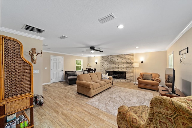 19130 NW 60th Ave, Reddick, FL 32686 - living room with crown molding, light wood-style flooring, a ceiling fan, a fireplace, and recessed lighting