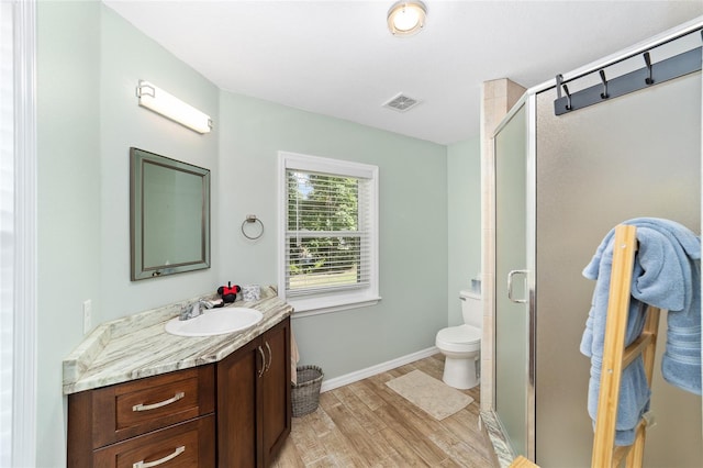 19130 NW 60th Ave, Reddick, FL 32686 - full bath featuring vanity, wood finished floors, and a stall shower
