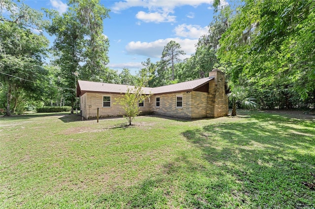 19130 NW 60th Ave, Reddick, FL 32686 - rear view of house featuring a chimney and a lawn