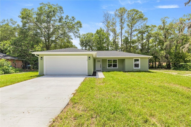 1708 NW 27th Ave, Ocala, FL 34475 - view of front of property featuring an attached garage, concrete driveway, stucco siding, and a front lawn