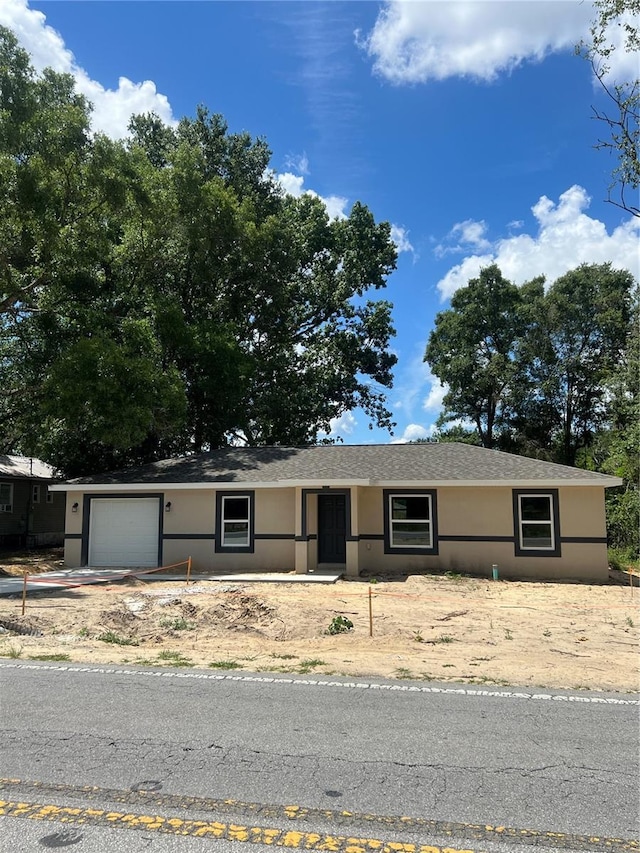 19622 SW Marine Blvd, Dunnellon, FL 34431 - view of front of house with a garage and stucco siding