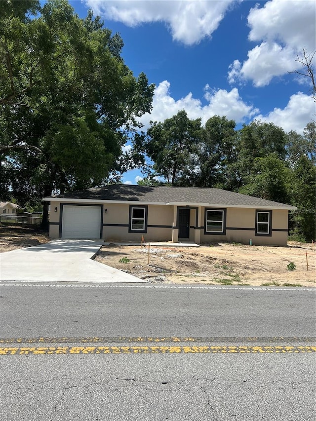 19622 SW Marine Blvd, Dunnellon, FL 34431 - ranch-style house featuring driveway, stucco siding, and an attached garage