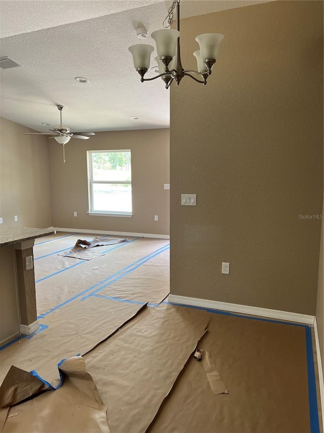 19622 SW Marine Blvd, Dunnellon, FL 34431 - empty room with a chandelier, a ceiling fan, and a textured ceiling