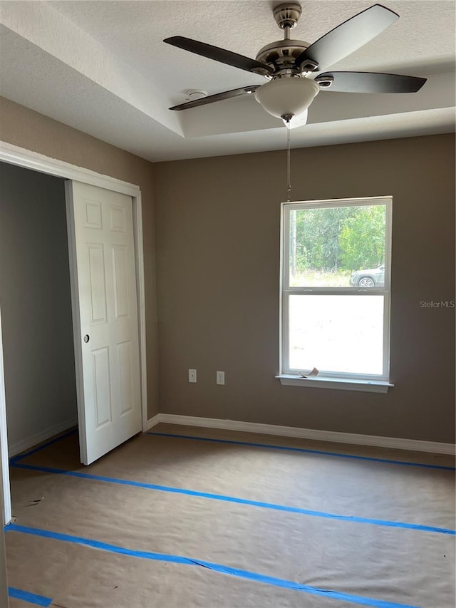 19622 SW Marine Blvd, Dunnellon, FL 34431 - unfurnished bedroom with ceiling fan, a closet, a textured ceiling, and concrete floors