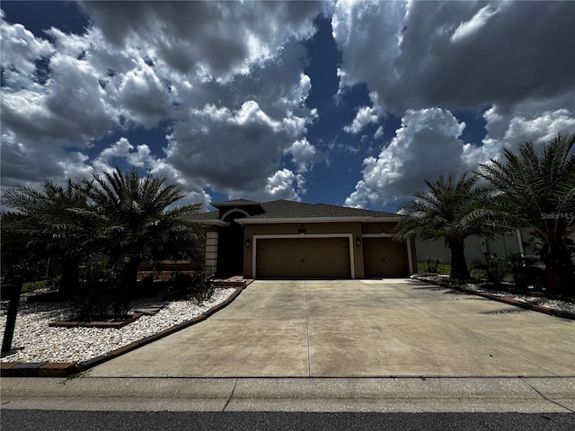 9238 SW 60th Court Rd, Ocala, FL 34476 - view of front of home featuring stucco siding, an attached garage, and driveway