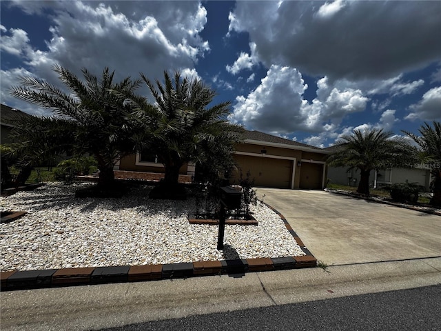 9238 SW 60th Court Rd, Ocala, FL 34476 - view of property hidden behind natural elements with driveway, a garage, and stucco siding