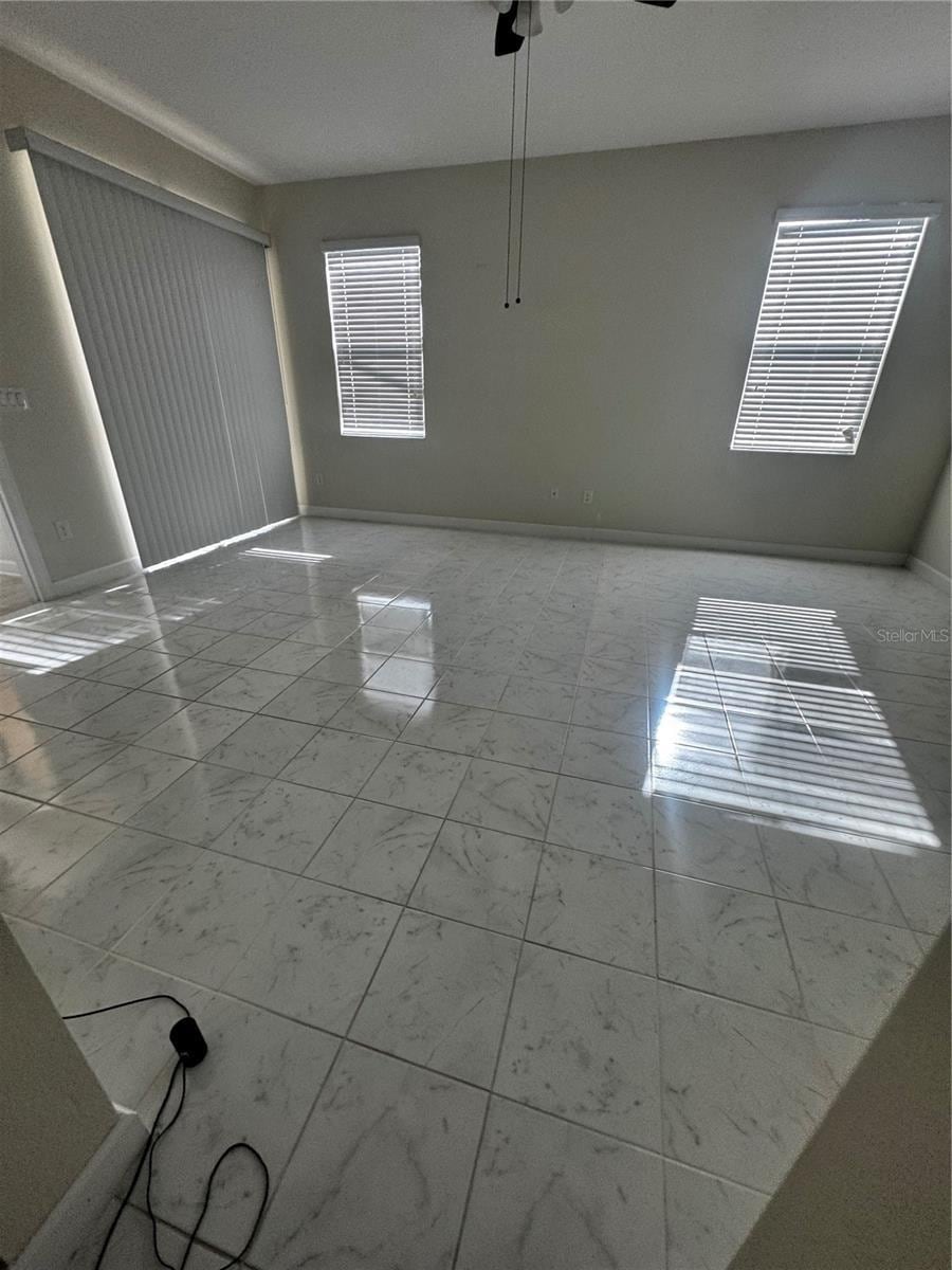 9238 SW 60th Court Rd, Ocala, FL 34476 - spare room with marble finish flooring and ceiling fan