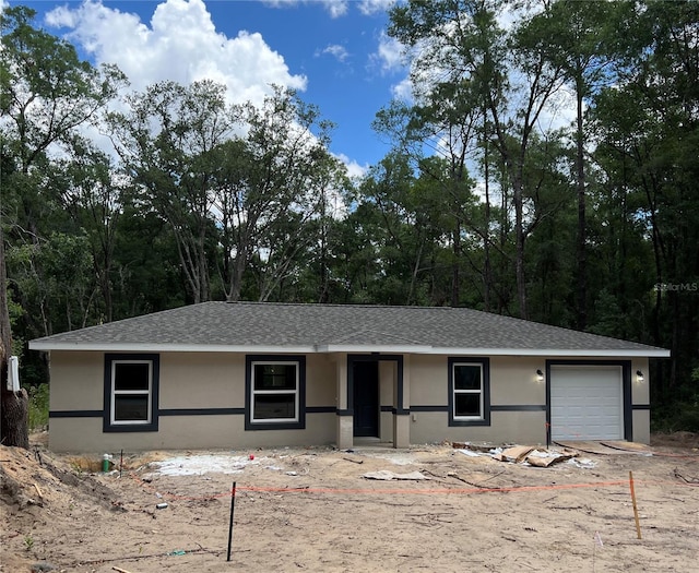 20769 SW Oriole Dr, Dunnellon, FL 34431 - ranch-style house with an attached garage, stucco siding, and a shingled roof