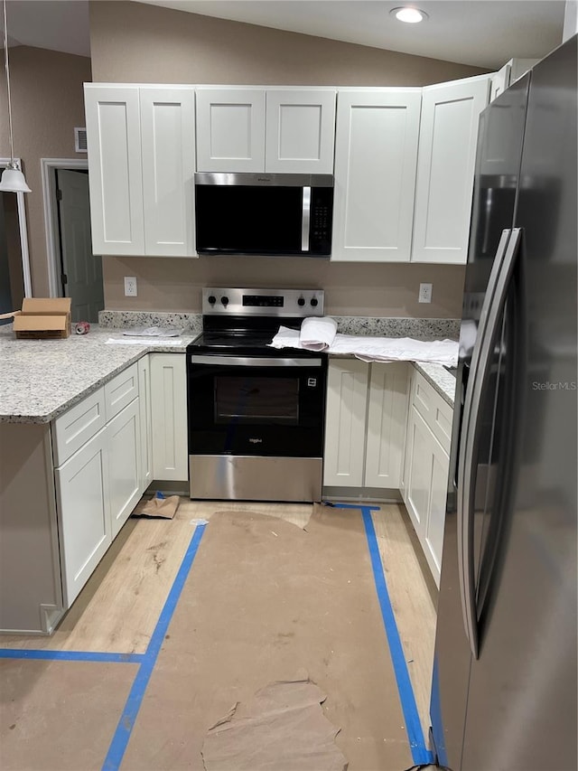 20769 SW Oriole Dr, Dunnellon, FL 34431 - kitchen featuring appliances with stainless steel finishes, a peninsula, white cabinetry, vaulted ceiling, and recessed lighting