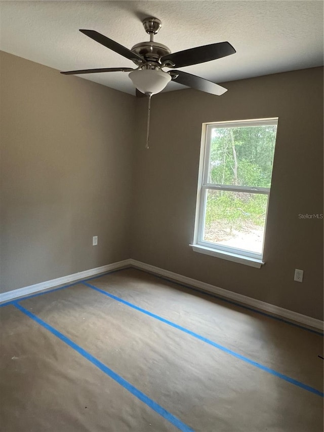 20769 SW Oriole Dr, Dunnellon, FL 34431 - empty room with concrete flooring, a ceiling fan, and a textured ceiling