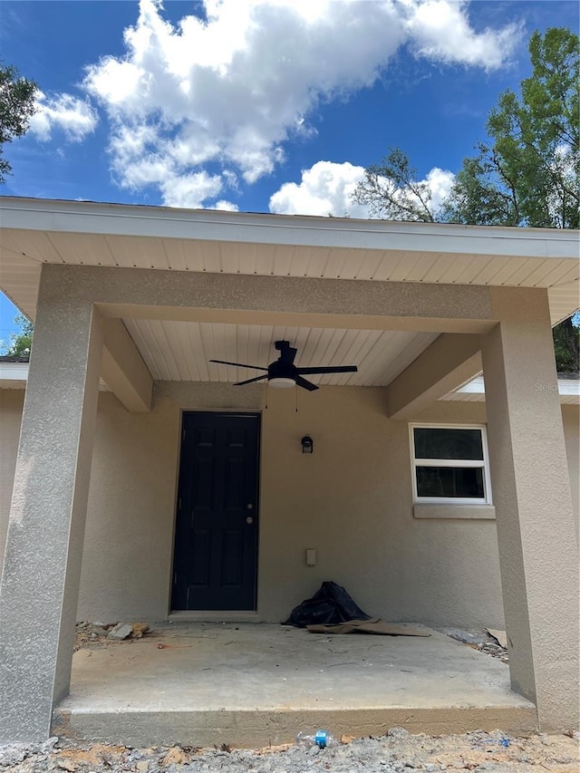 20769 SW Oriole Dr, Dunnellon, FL 34431 - view of exterior entry featuring stucco siding and ceiling fan