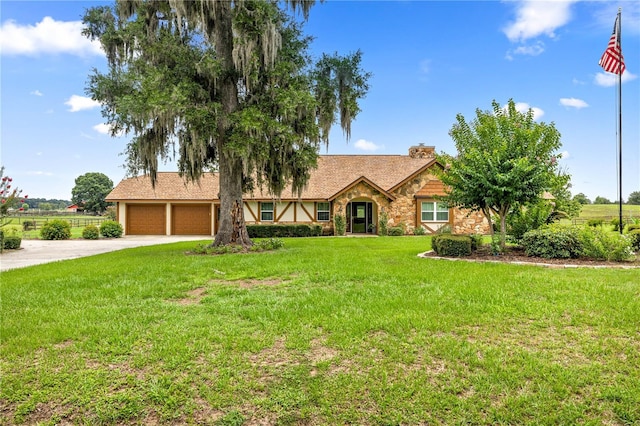 12131 NE 10th Ter, Ocala, FL 34479 - view of front of home featuring stone siding, concrete driveway, a front lawn, a chimney, and an attached garage