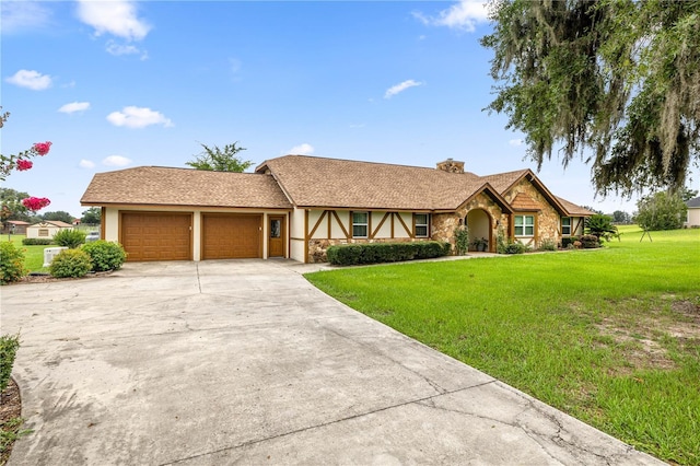 12131 NE 10th Ter, Ocala, FL 34479 - view of front of home with stone siding, stucco siding, a garage, a chimney, and a front lawn