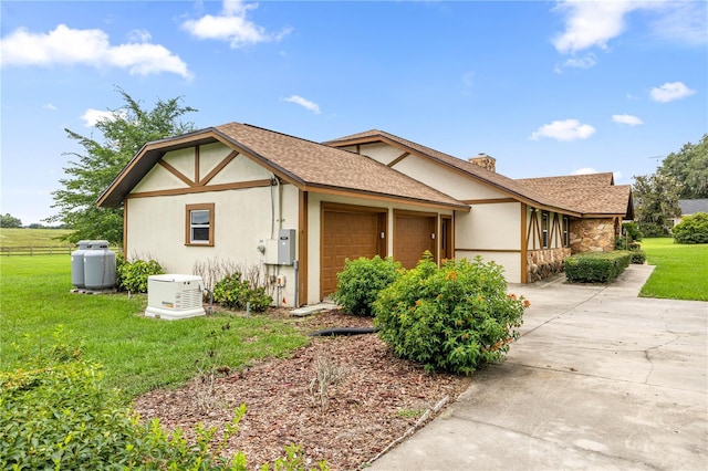 12131 NE 10th Ter, Ocala, FL 34479 - view of home's exterior with a garage, stucco siding, concrete driveway, a chimney, and a shingled roof