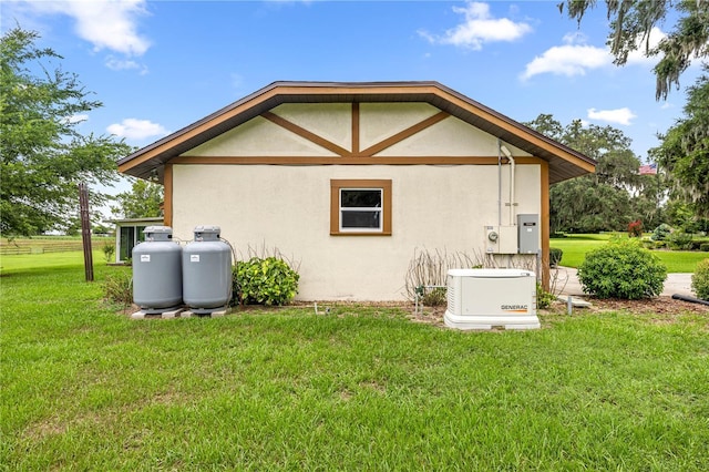 12131 NE 10th Ter, Ocala, FL 34479 - view of home's exterior with stucco siding and a lawn
