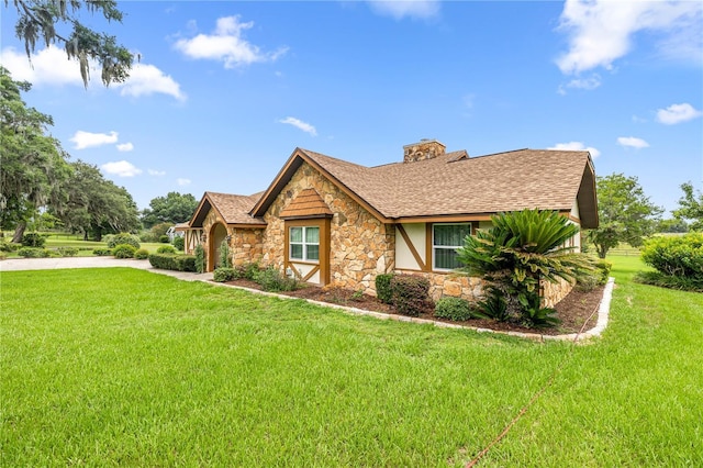 12131 NE 10th Ter, Ocala, FL 34479 - tudor home with stone siding, a front lawn, a chimney, stucco siding, and a shingled roof