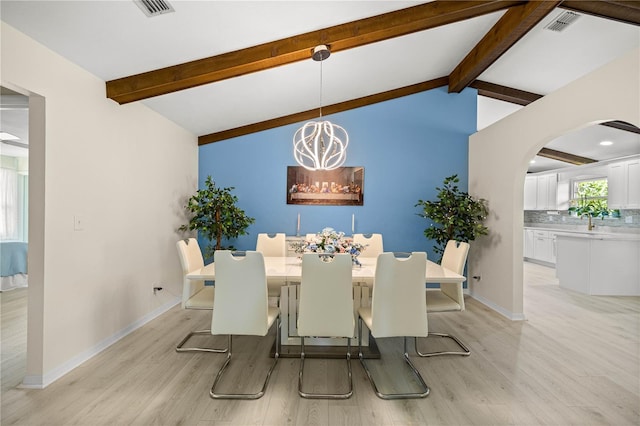 12131 NE 10th Ter, Ocala, FL 34479 - dining area featuring arched walkways, light wood-style flooring, and a chandelier