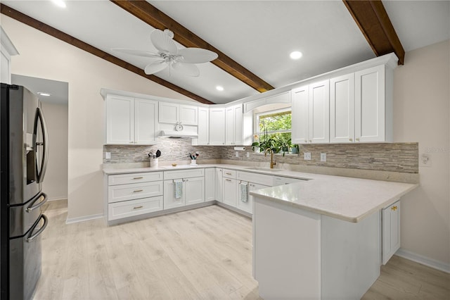 12131 NE 10th Ter, Ocala, FL 34479 - kitchen with stainless steel fridge, a peninsula, tasteful backsplash, light wood-type flooring, and recessed lighting