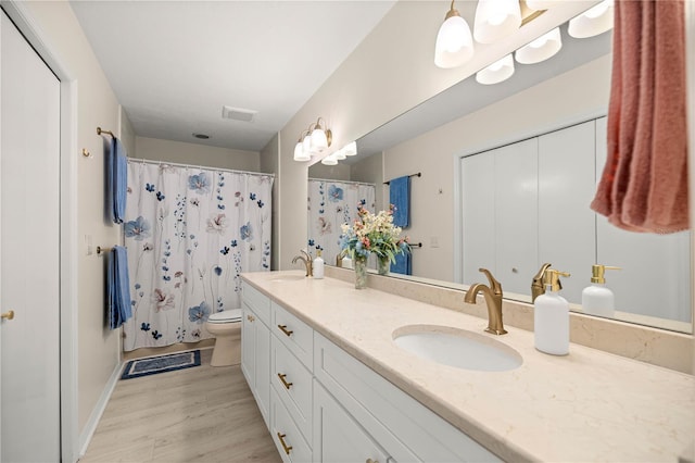 12131 NE 10th Ter, Ocala, FL 34479 - full bathroom featuring double vanity, wood finished floors, and a shower with curtain