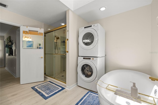 12131 NE 10th Ter, Ocala, FL 34479 - bathroom with stacked washer and clothes dryer, a shower stall, wood finished floors, a soaking tub, and recessed lighting