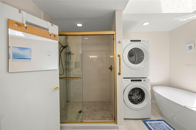 12131 NE 10th Ter, Ocala, FL 34479 - bathroom with stacked washer and clothes dryer, a stall shower, a soaking tub, recessed lighting, and wood finished floors
