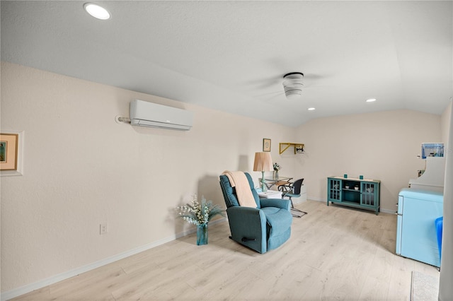 12131 NE 10th Ter, Ocala, FL 34479 - sitting room featuring a wall mounted air conditioner, washer / dryer, wood finished floors, ceiling fan, and lofted ceiling