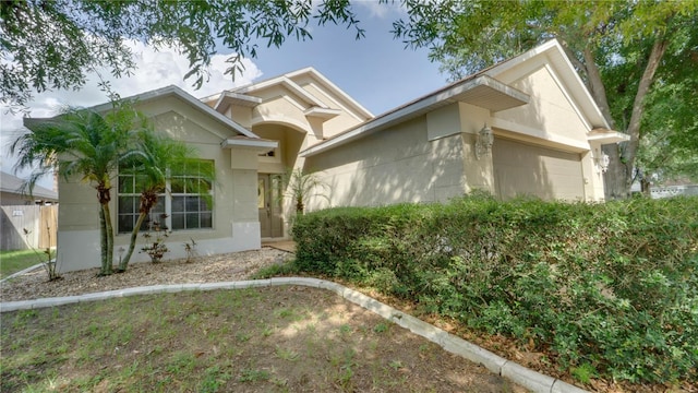 949 Woodsong Way, Clermont, FL 34714 - ranch-style house featuring a garage and stucco siding